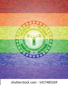 weightlifter girl icon inside emblem on mosaic background with the colors of the LGBT flag