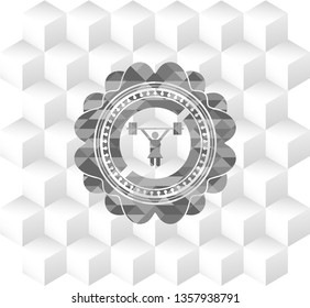weightlifter girl icon inside grey emblem with geometric cube white background