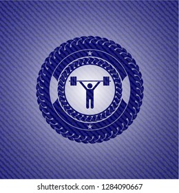 weightlifting icon inside badge with denim background