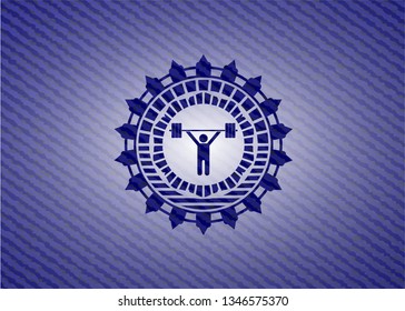weightlifting icon inside badge with denim texture