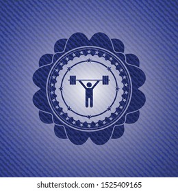 weightlifting icon inside badge with jean texture