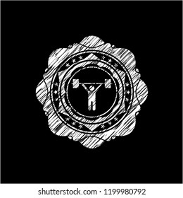 weightlifting icon inside chalkboard emblem on black board