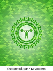 weightlifting icon inside green emblem with mosaic background