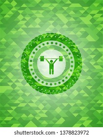 weightlifting icon inside green emblem with mosaic background