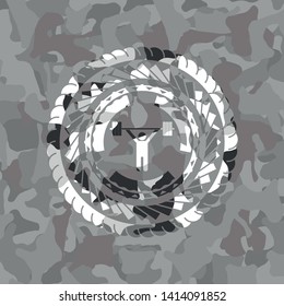 weightlifting icon inside grey camouflaged emblem