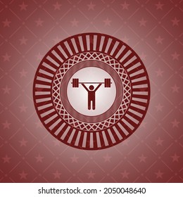 icono de levantamiento de pesas dentro del emblema rojo. 