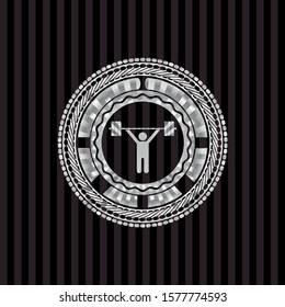 weightlifting icon inside silvery emblem or badge
