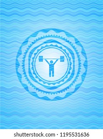 weightlifting icon inside sky blue water wave badge.