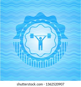 weightlifting icon inside sky blue water wave badge background.