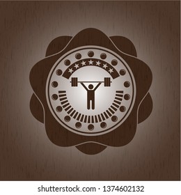 weightlifting icon inside wood emblem