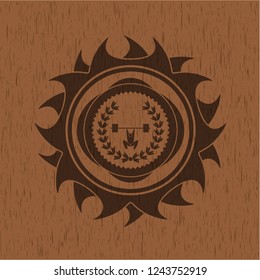 weightlifting inside of crown icon inside badge with wooden background