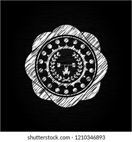 weightlifting inside of crown icon inside chalkboard emblem written on a blackboard