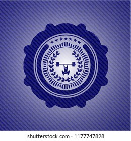 weightlifting inside of crown icon inside emblem with jean background