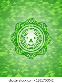 weightlifting inside of crown icon inside green emblem with mosaic background