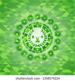 weightlifting inside of crown icon inside green mosaic emblem