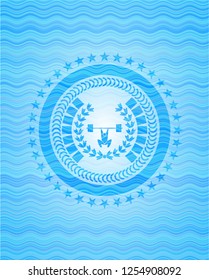weightlifting inside of crown icon inside sky blue water wave emblem.