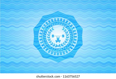 weightlifting inside of crown icon inside water representation emblem.