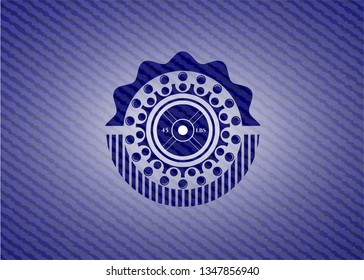 weightlifting or powerlifting plate (45 lbs) icon inside emblem with jean background