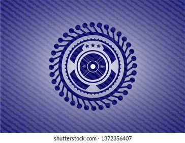 weightlifting or powerlifting plate (45 lbs) icon inside badge with jean texture