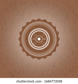 weightlifting or powerlifting plate (45 lbs) icon inside badge with wood background