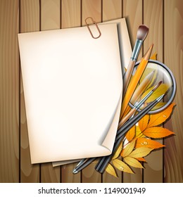 Welcome back to school background. School items and elements. Paper sheet with autumn leaves, pens, pencils, brushes and magnifying glass on wooden table