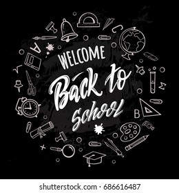 Welcome back to school. Hand-drawn lettering surrounded by school supplies with  on black background. Imitation of chalk drawing on the blackboard. Vector poster.