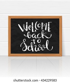 Welcome back to school handdrawn on board. Chalck lettering over calckboard, vector illustration