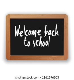 Welcome Back to School lettering. Vector hand written phrase on a blackboard. Isolated on white background. Clipping paths included.
