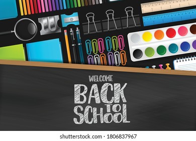 Welcome back to school sign on blackboard with wooden frame. Colorful stationery on dark background. Vector illustration.