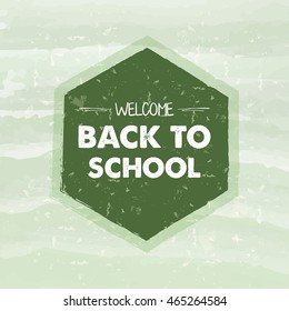 welcome back to school text in hexagon frame over green old paper background, education concept, vector