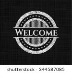 Welcome chalk emblem written on a blackboard