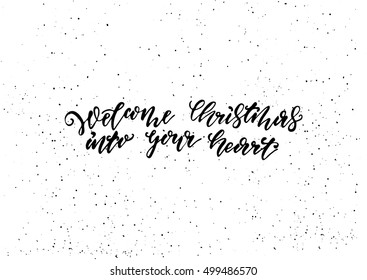 Welcome Christmas into your heart - freehand ink hand drawn calligraphic design for Xmas greetings cards, invitations. Handwritten calligraphy on black subtle ink spotted texture background