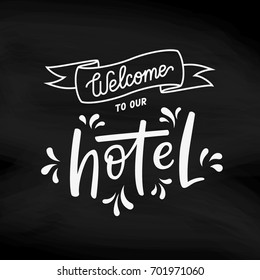 Welcome to our hotel sign. Welcoming greeting design for hotel / motel / hostel / host reception desk. White on black, chalk on blackboard. Modern calligraphy lettering vector illustration. svg
