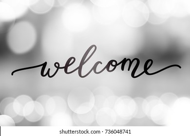 welcome vector lettering on blurred lights background