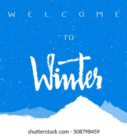 Welcome winter inscription white snowfall with mountain rock winter background