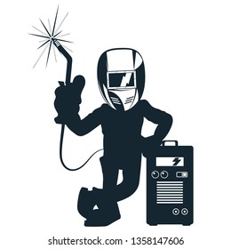 Welder in mask with welding machine in hand