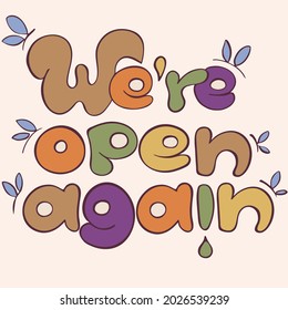 We're open again sign in soft beige pastel colors. Lettering sign for customers about re-opening of shops, businesses and other place were closed because of lockdown during coronavirus pandemic