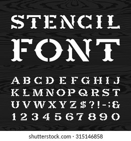 Western style retro alphabet stencil font. Serif type dirty letters, numbers and symbols on the dark wood textured background. Vintage vector typography for labels, headlines, posters etc.