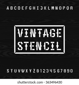 Western style retro stencil alphabet font. Letters and numbers on a wooden background. Vintage vector typography for labels, headlines, posters etc.