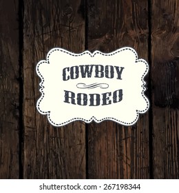 Western styled label on aged wooden wall background