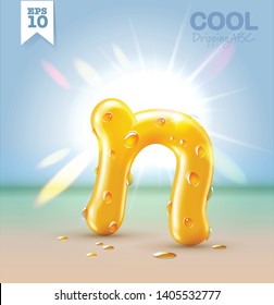 Wet yellow glossy vector font - N with fresh water drops on it hanging over the beach under the bright sun. Vector realistic typeset.