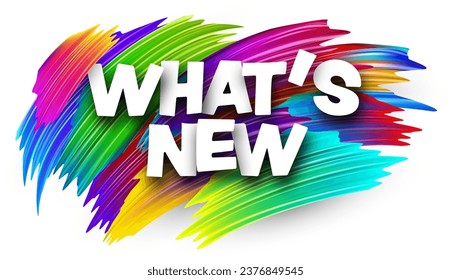 What's new paper word sign with colorful spectrum paint brush strokes over white. Vector illustration.