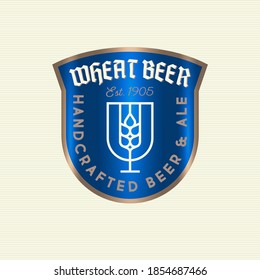 Wheat Beer Logo. Beer Pub or Old Brewing Company Emblem. Spikelet in a Beer Glass like a Blue Heraldic Shield. Label, packaging design.