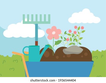 wheelbarrow watering can and flowers