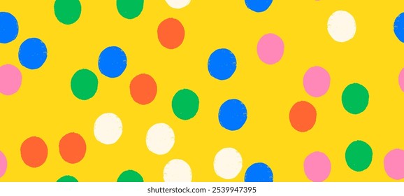 Whimsical seamless vector polka dot pattern with playful crayon spots and colorful confetti. Primary colored design for party or carnival yellow background.