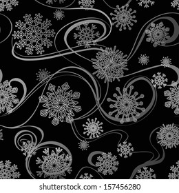 Whirl of silver snowflakes seamless pattern on a black background