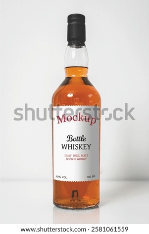 Whiskey bottle mockup with label on white background. Realistic alcoholic drink in a bottle with emblem logo. Editable vector mockup