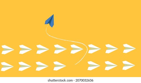 White airplanes flying in same direction on yellow background and blue airplane flying in different direction.Conceptual leadership image,different thinking concept.