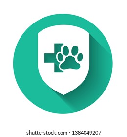 White Animal health insurance icon isolated with long shadow. Pet protection icon. Dog or cat paw print. Green circle button. Vector Illustration
