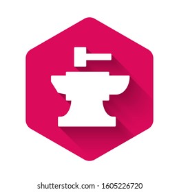 White Anvil for blacksmithing and hammer icon isolated with long shadow. Metal forging. Forge tool. Pink hexagon button. Vector Illustration